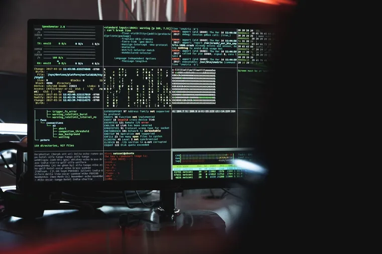 Security operations terminal with code on dark screens