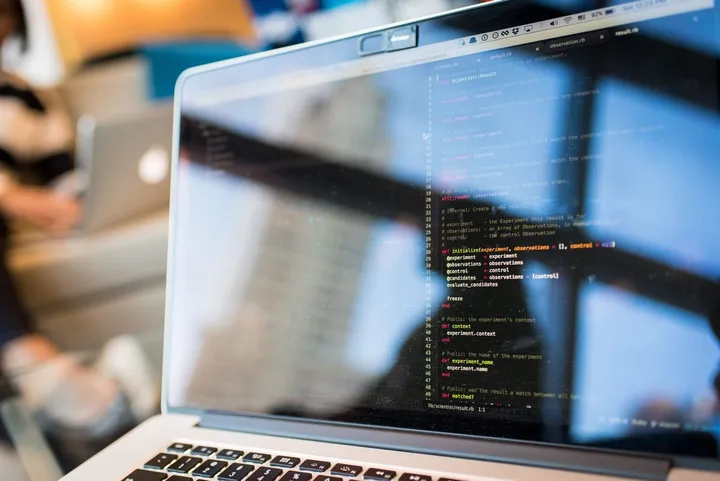 Developer writing code on a laptop