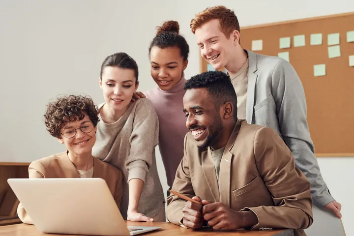 Project team collaborating around a laptop